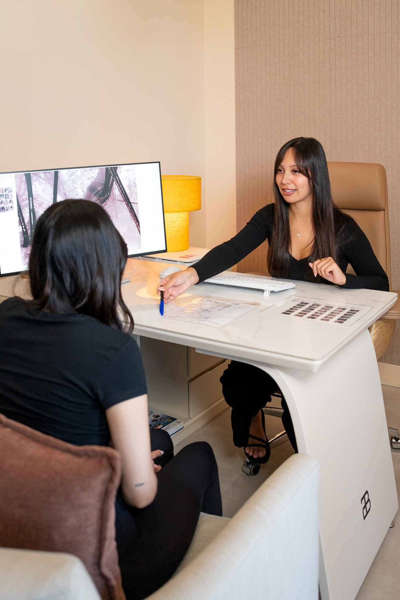 Invita therapist consulting with a guest at Invita Head Spa Costa Mesa